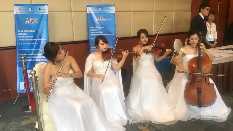 A group of violinists outside of the conference room