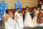 A group of violinists outside of the conference room